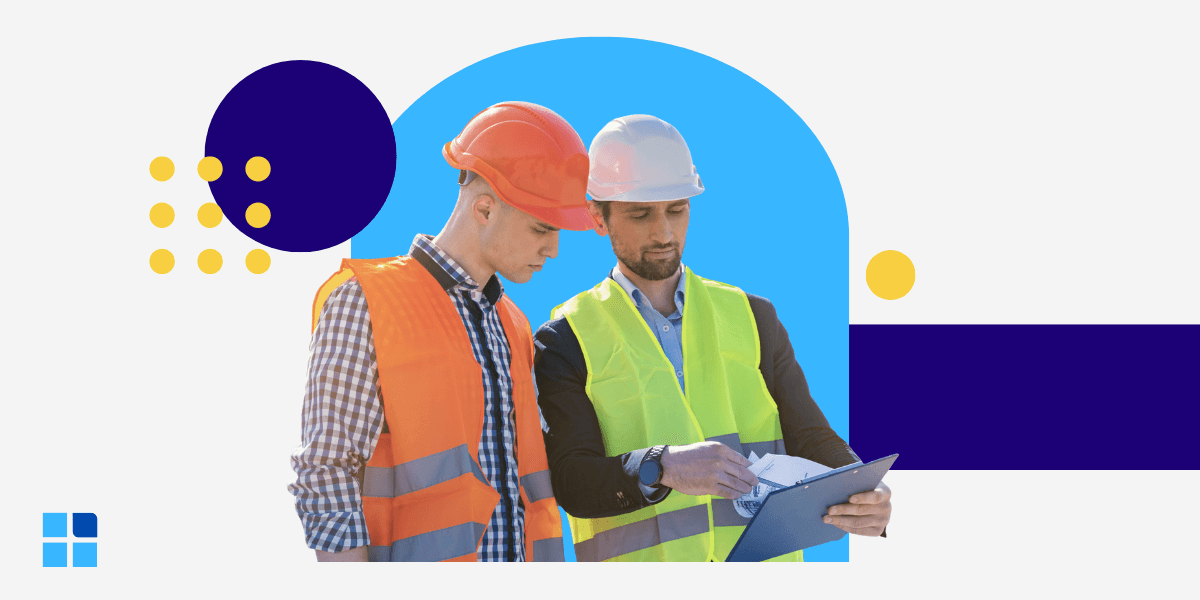 A manager in a hard hat uses a clipboard to instruct a worker.