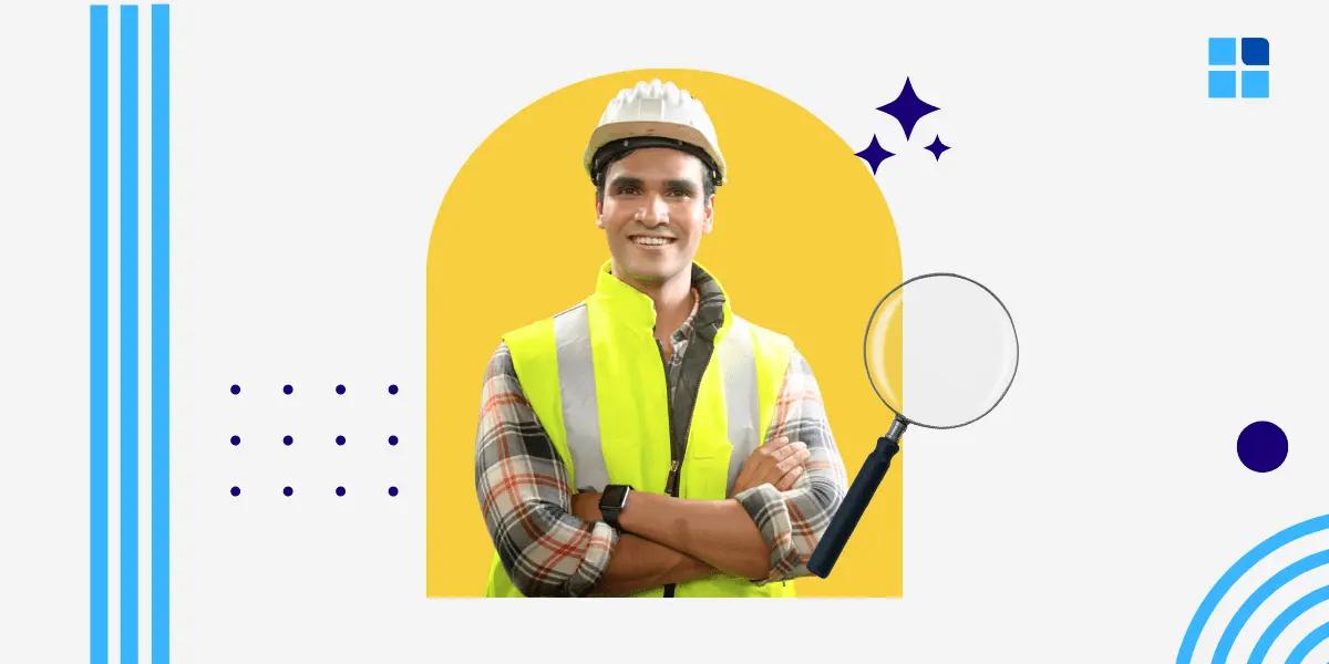 Man in a hard hat and yellow vest smiles confidently, arms crossed, against a yellow arch.