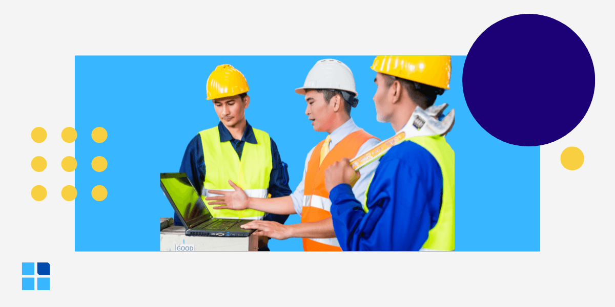 3 construction workers wearing safety vests & helmets focus on a laptop, discussing a project.