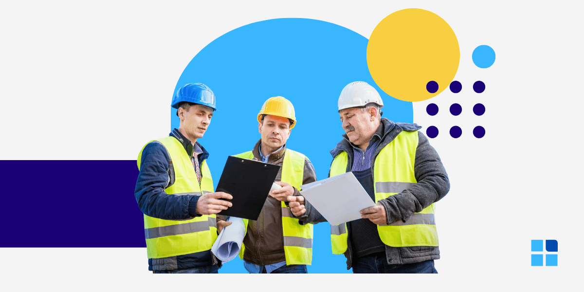 Three construction workers in hard hats and vests review documents .