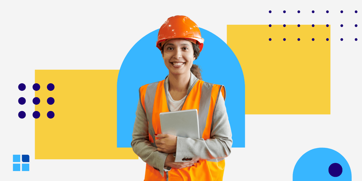 A smiling woman in an orange safety vest and hard hat holds a tablet.