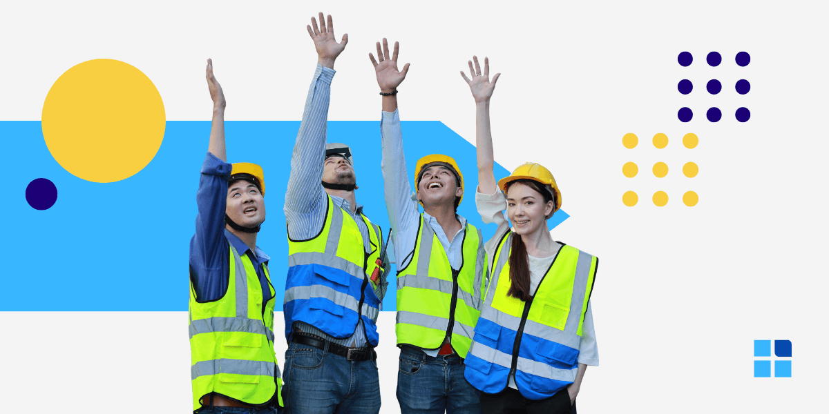 Four construction workers in safety vests and helmets raise their hands joyfully.